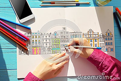 Woman sitting at table with coloring book for adults Stock Photo