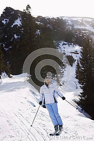 Woman Skiing Down Slope Stock Photo