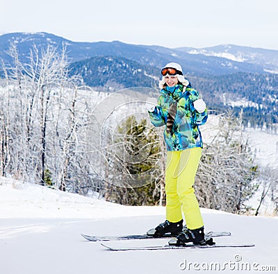 Woman skiing showing thumbs up Stock Photo