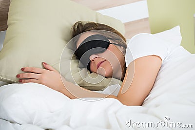 Woman Sleeping On Bed With An Eye Mask Stock Photo