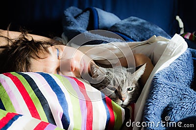 Woman sleeping with cat Stock Photo