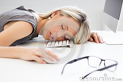 Woman sleeping in front of computer Stock Photo