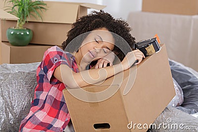 Woman sleeping over package for house moving Stock Photo