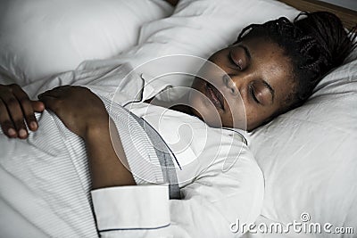 A woman sleeping soundly on bed Stock Photo