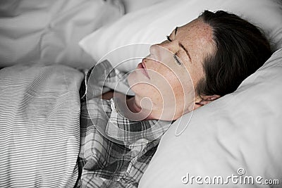 A woman sleeping soundly on bed Stock Photo