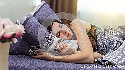 Woman sleeps sound restful sleep in her bed Stock Photo