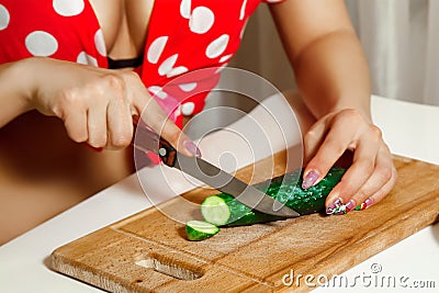 Woman sliced cucumber on a cutting board Stock Photo