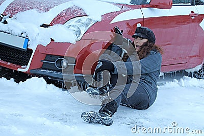 A woman slipped in winter and fell in front of a car Stock Photo