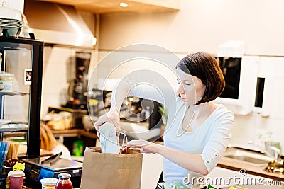 Woman small local shop owner packing shopping Stock Photo