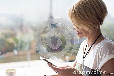 Woman smartphone Paris cafe Stock Photo