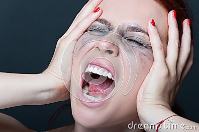 Woman with smeared mascara screaming Stock Photo