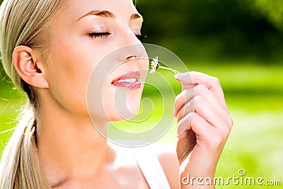 Woman Smelling Flower Stock Photo