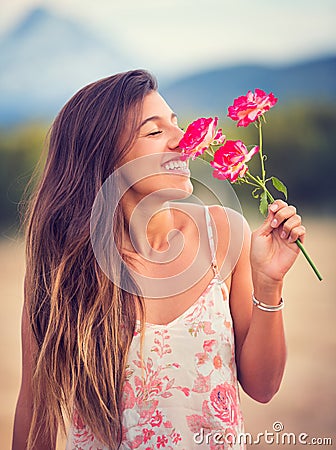Woman smelling flowers in nature Stock Photo