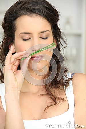 Woman smelling onions branch Stock Photo