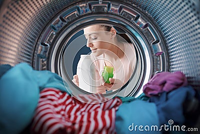 Woman smelling a scented laundry detergent Stock Photo