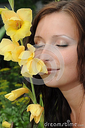Woman smells the flower Stock Photo
