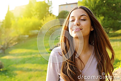 Woman smiling looking up taking deep breath celebrating freedom. Positive human emotion face expression feeling life perception Stock Photo