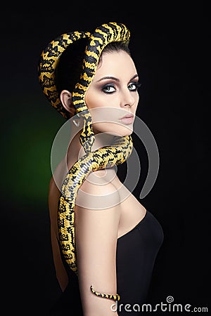 Woman with Snake on her head like a hair Stock Photo