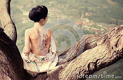 Woman with snake tattoo on her back Stock Photo