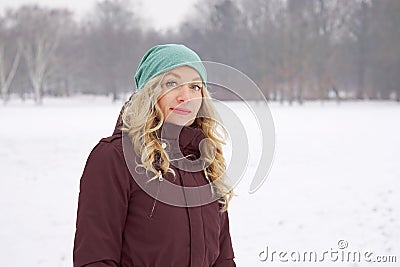 Woman in snow covered park in winter Stock Photo