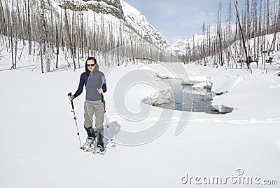 Woman snowshoeing in the Canadian rockies Stock Photo