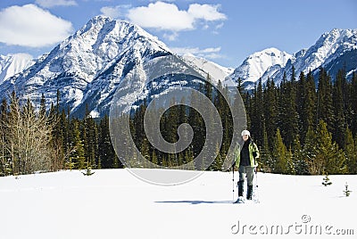 Woman snowshoeing in the Canadian rockies Stock Photo