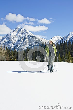 Woman snowshoeing in the Canadian rockies Stock Photo