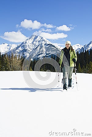 Woman snowshoeing in the Canadian rockies Stock Photo