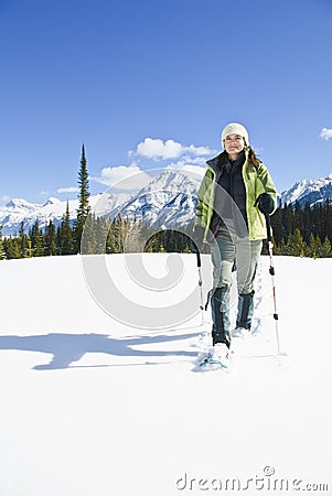 Woman snowshoeing in the Canadian rockies Stock Photo
