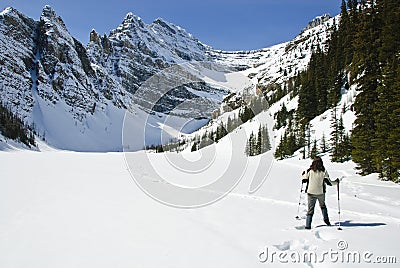 Woman snowshoeing in the Canadian rockies Stock Photo