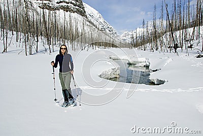 Woman snowshoeing in the Canadian rockies Stock Photo