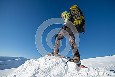 Woman snowshoeing in winter Carpathian mountains Stock Photo