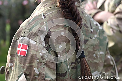 Woman soldier. Woman in army. Flag of Denmark on soldiers arm. Denmark military uniform. Danish troops Stock Photo