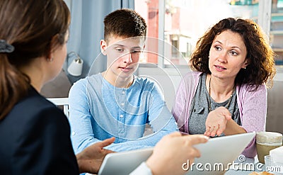 Woman with son meeting with tutor Stock Photo