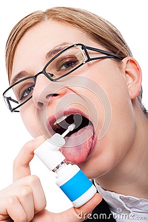 Woman with sore throat using oral spray Stock Photo