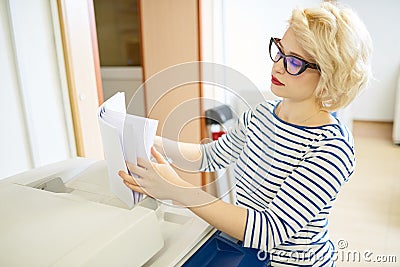 Woman sorting paper in printing office Stock Photo