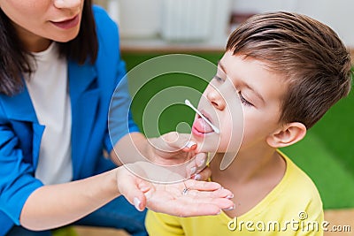 A woman speech therapist deals with the child and teaches him the correct pronunciation and competent speech Stock Photo