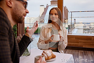 Woman spending time with man during speed dating in cozy coffeeshop Stock Photo