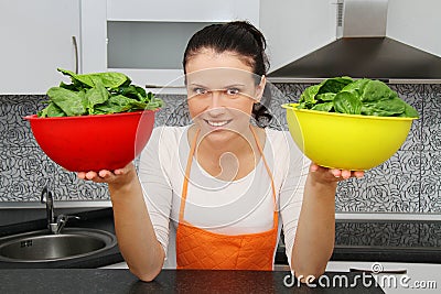 Woman with a spinach in a modern kitchen Stock Photo