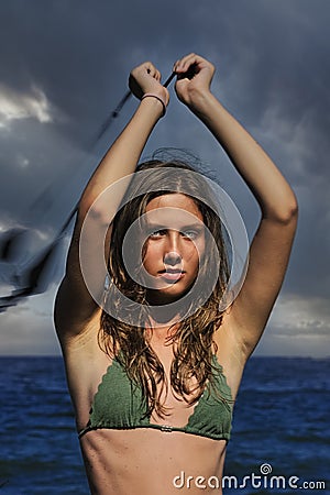 Woman spinning poi on the beach. Stock Photo