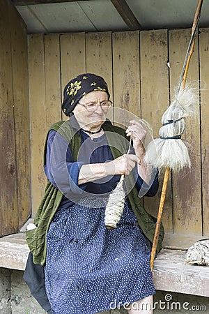 A woman spinning wool in Romania Editorial Stock Photo