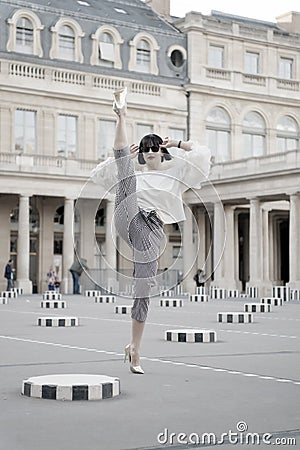 Woman split leg on square in paris, france Stock Photo