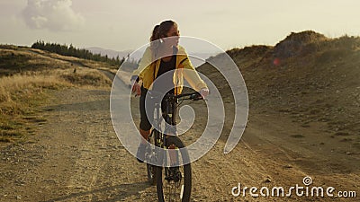 Woman on sport bike riding on mountain road. Female bicyclist training outdoor Stock Photo