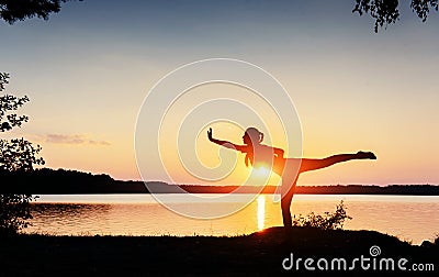 Woman sporting appearance at sunset near the water Stock Photo