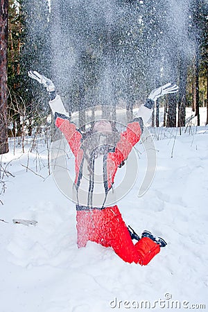 Woman in a sporting suit tosses up snow in-field Stock Photo