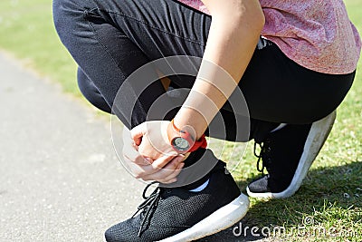 Woman With Sports Injury Sustained Whilst Jogging In Park Stock Photo