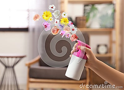 Woman spraying air freshener at home. Flowered aroma Stock Photo