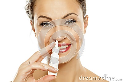 Woman spraying nasal drops Stock Photo