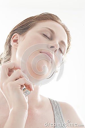 Woman spraying perfume Stock Photo