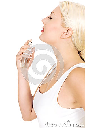 Woman spraying perfume on neck Stock Photo